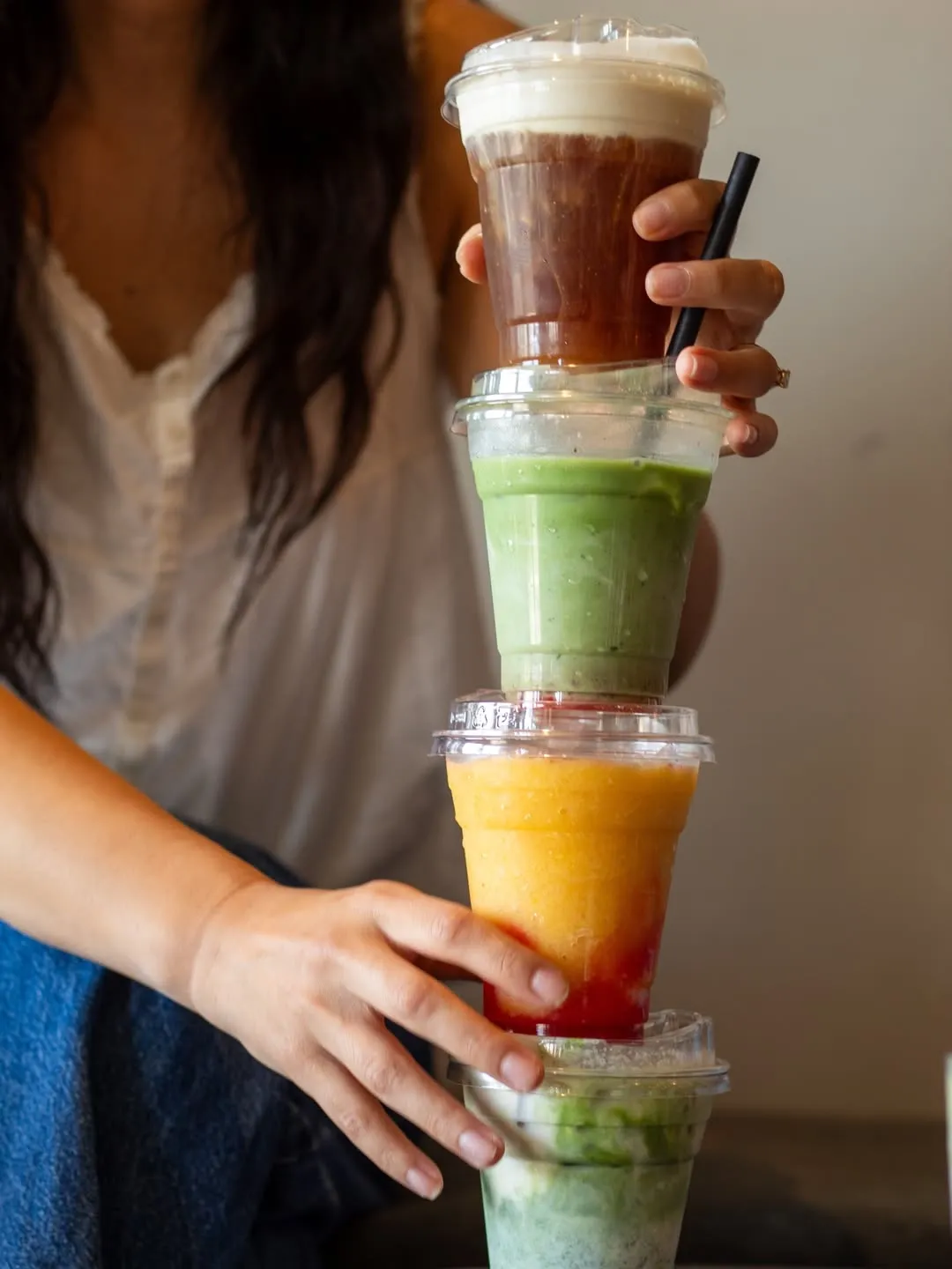 Three iced drinks lined up on the counter